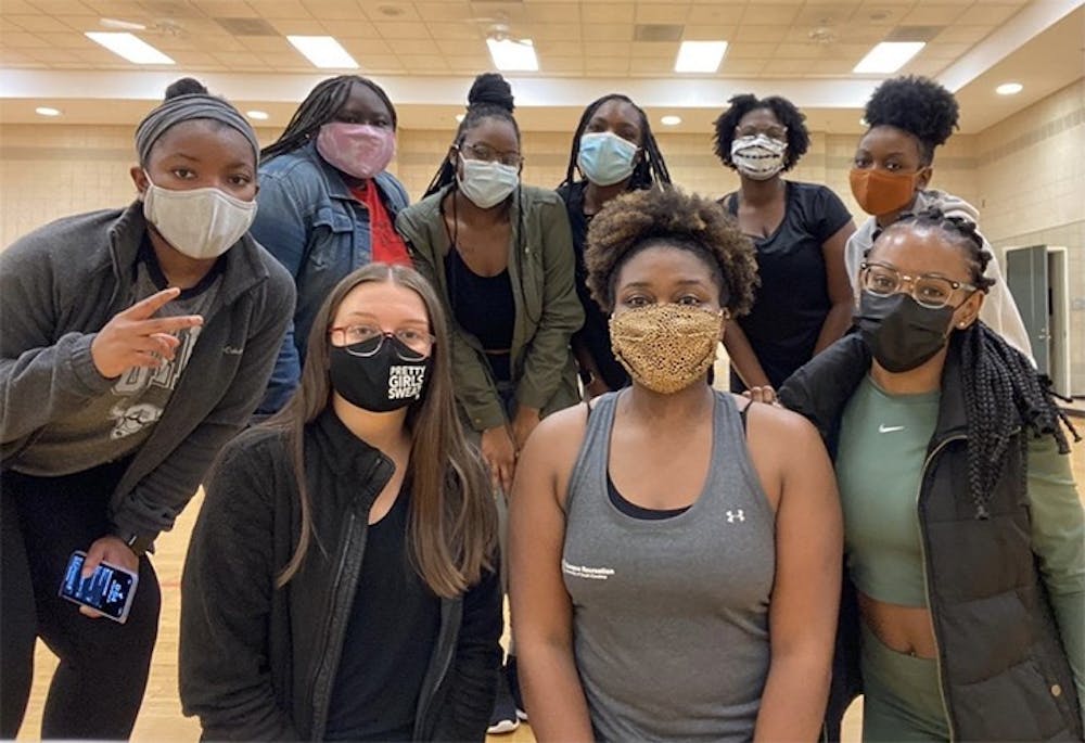 <p>Members of USC's PRETTY GIRLS SWEAT chapter pose in masks for a picture. The chapter helps and encourages women to establish a healthy lifestyle.</p>