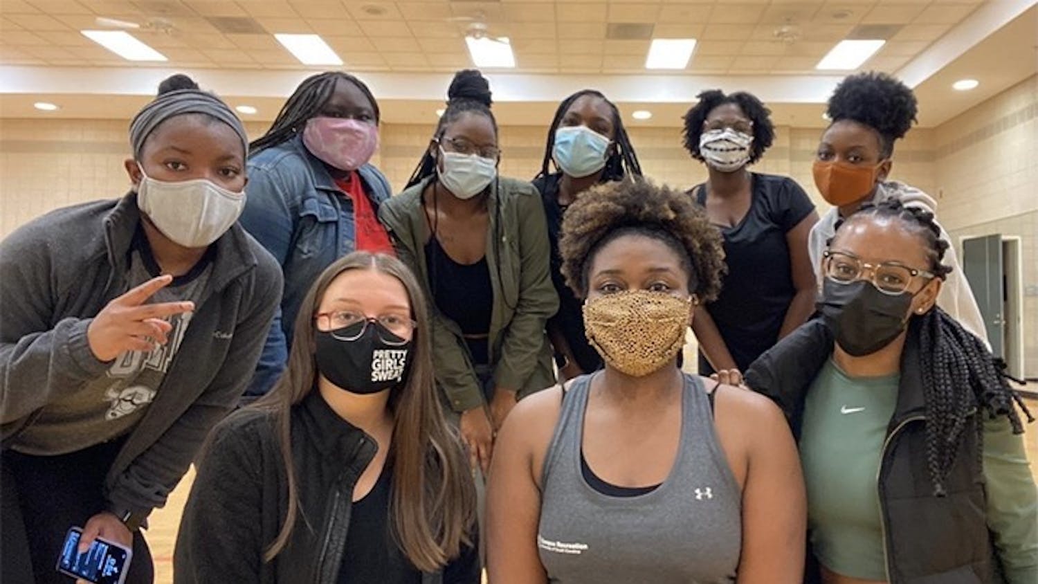 Members of USC's PRETTY GIRLS SWEAT chapter pose in masks for a picture. The chapter helps and encourages women to establish a healthy lifestyle.