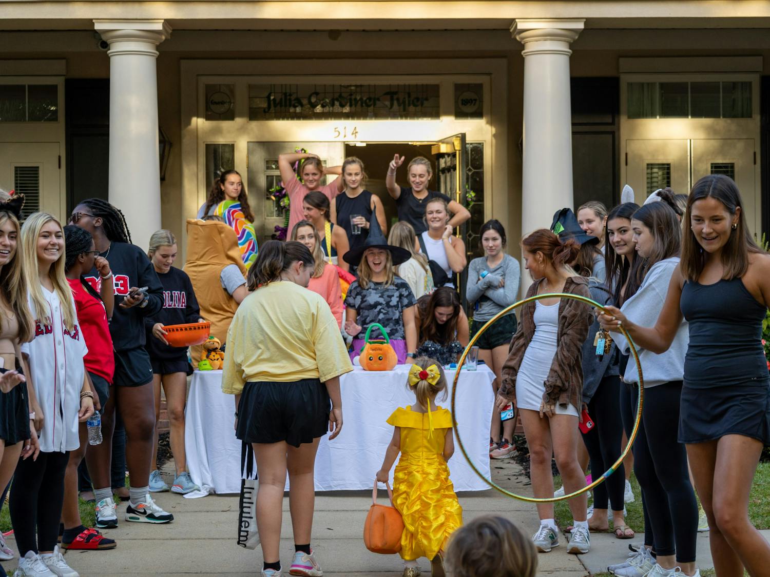 Members of a USC sorority stand outside of the sorority house entertaining costumed trick or treaters with games and toys on Oct. 25, 2022. USC Greek fraternities and sororities played games and hosted fun activities for children as they approached each candy table.