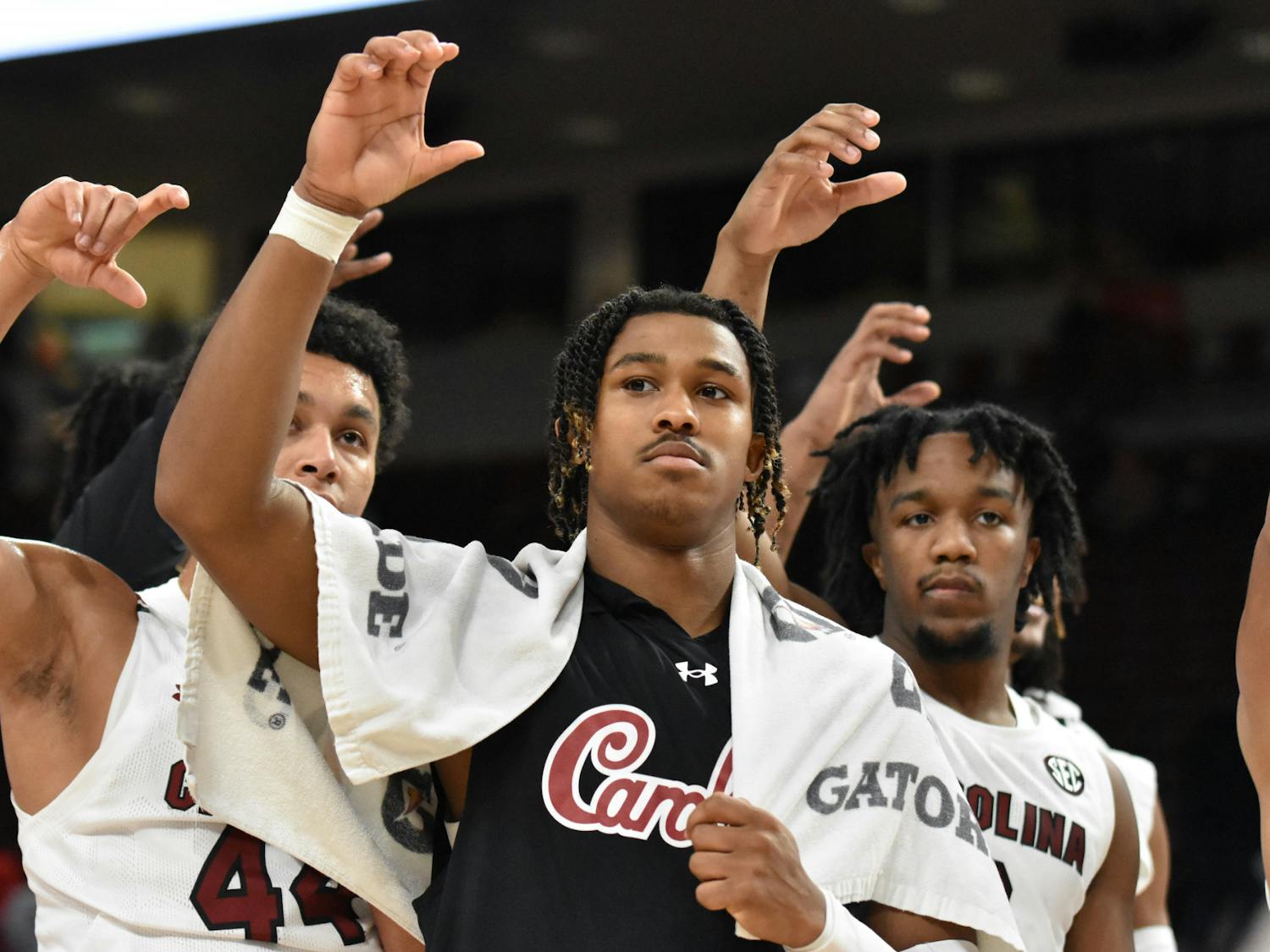 Junior guard Meechie Johnson raises his hand alongside his teammates during the alma mater at the end of the team's scrimmage on Nov. 2, 2022. The Gamecocks took on Mars Hill and won 80-41. 