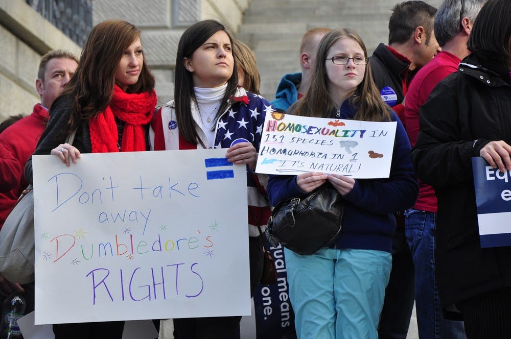 Those who had been affected by the Defense of Marriage Act were asked to come forward and stand on the Statehouse steps at Tuesday's rally.