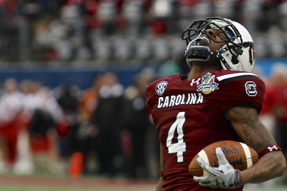 	Sophomore wide receiver Shaq Roland celebrates one of his six catches for 112 yards in the Gamecocks&#8217; 34-24 win over Wisconsin in the 2014 Capital One Bowl.