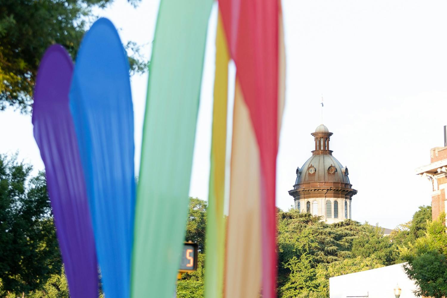 A picture of rainbow banners in front of the statehouse on June 4, 2022. The banners marked the location of Outfest, a showcase that focused on the LGBTQIA+ community with local vendors, businesses and talent during national Pride month.