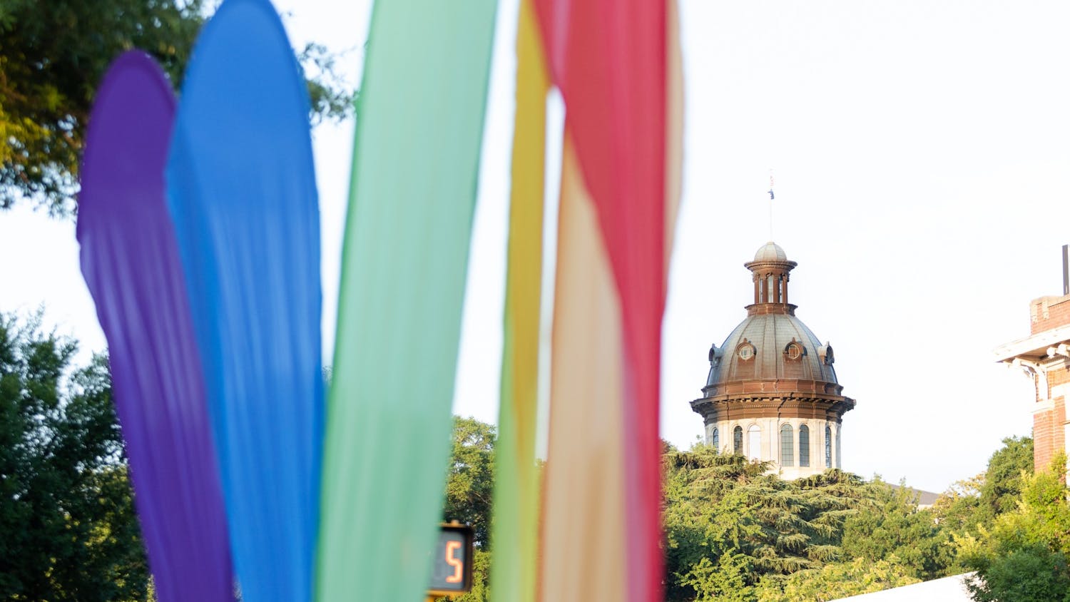 A picture of rainbow banners in front of the statehouse on June 4, 2022. The banners marked the location of Outfest, a showcase that focused on the LGBTQIA+ community with local vendors, businesses and talent during national Pride month.