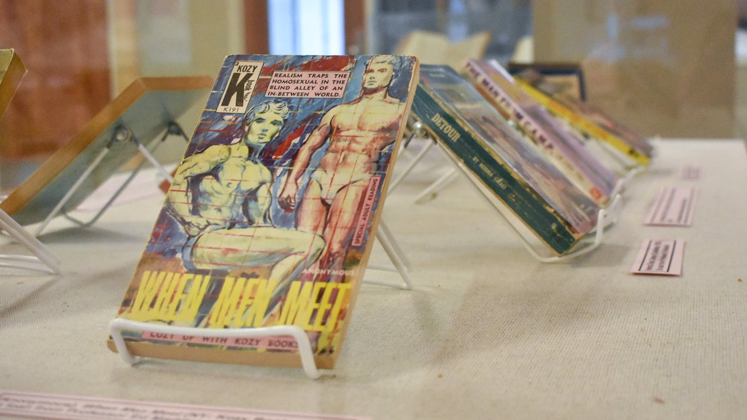 The book "When Men Meet" is displayed alongside other books highlighting queer identities in the “To tell the secret of my nights and days” exhibit. The collection of books, newspapers, photos and magazines in the Thomas Cooper Library is open until January 2024.