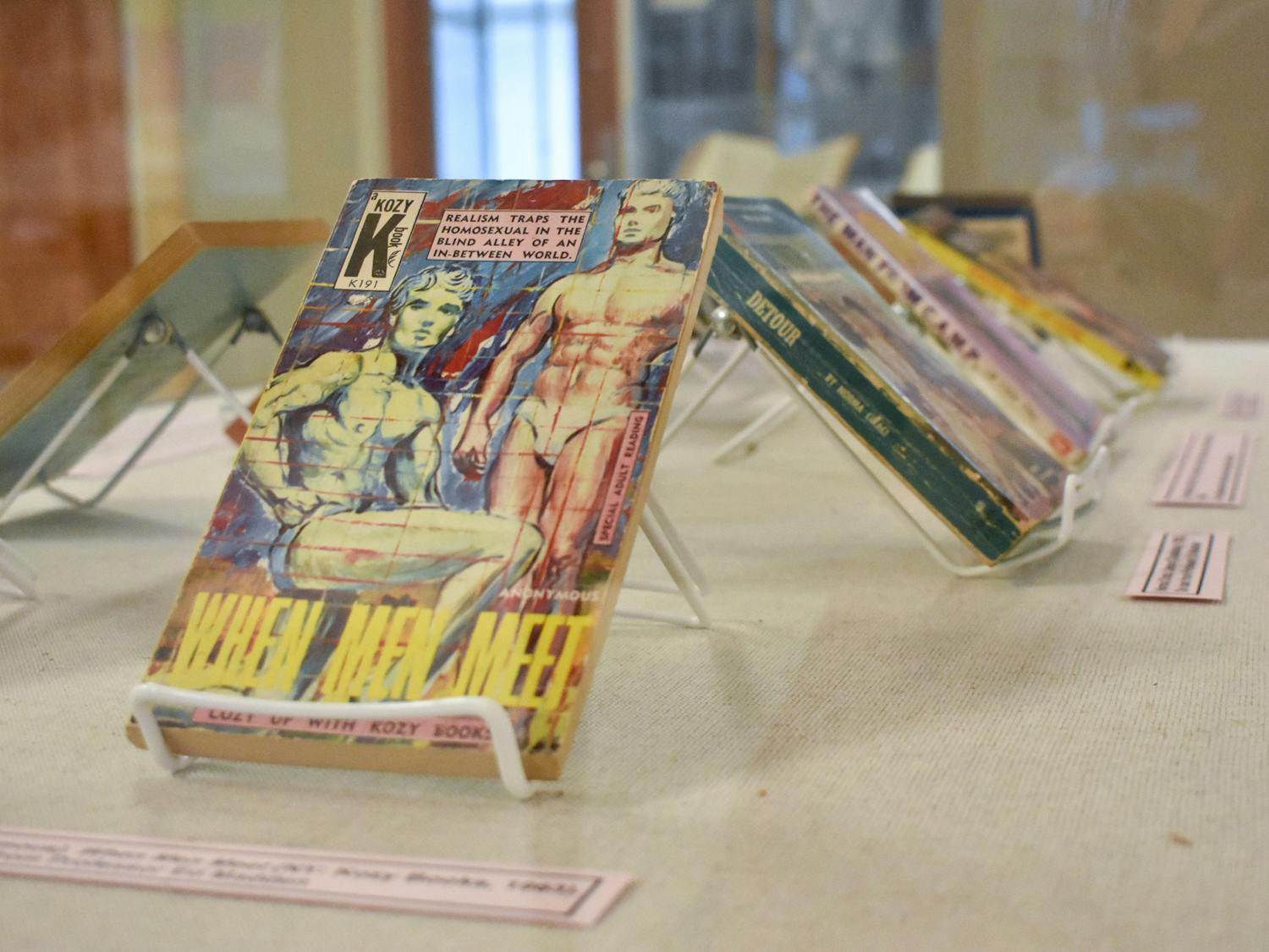 The book "When Men Meet" is displayed alongside other books highlighting queer identities in the “To tell the secret of my nights and days” exhibit. The collection of books, newspapers, photos and magazines in the Thomas Cooper Library is open until January 2024.