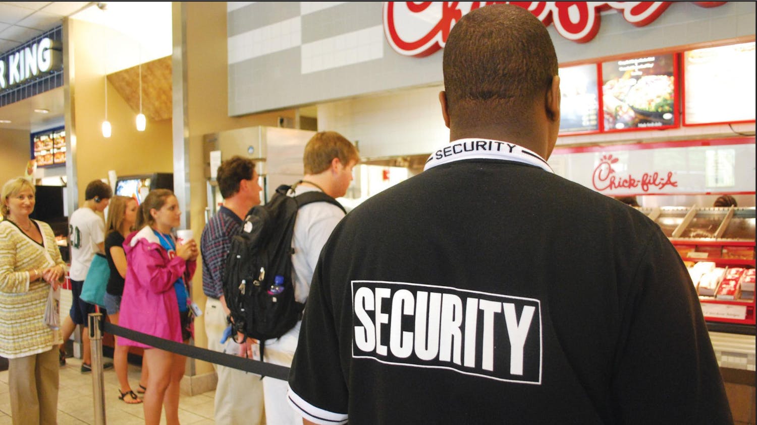 A photo of a security guard in Russell House in 2009. In order to prevent students from stealing food, USC hired security guards to watch over people that were picking up food.