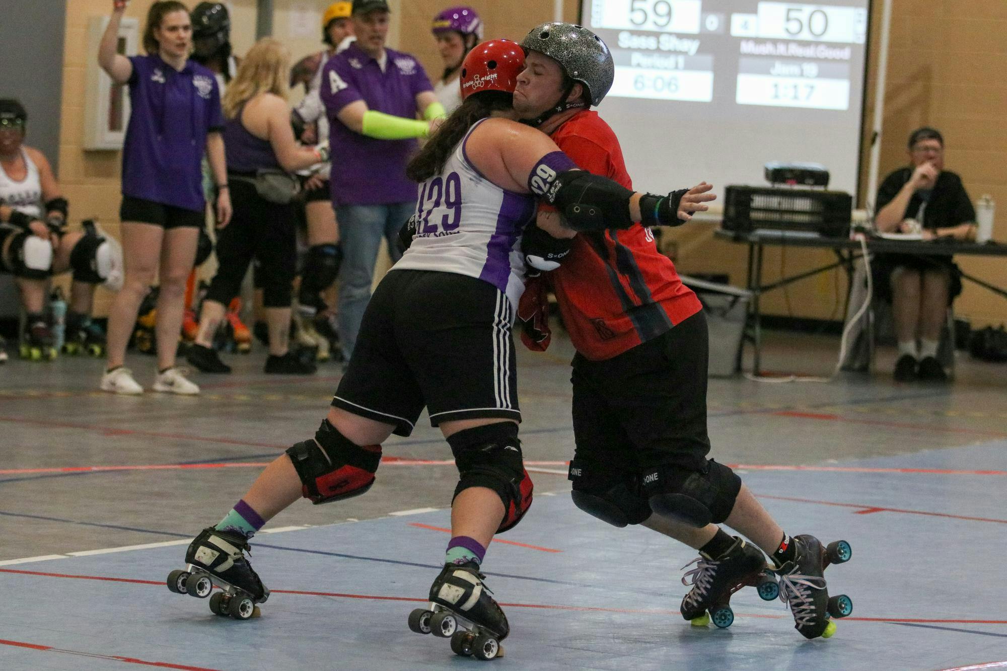 Red Stick All Star skater Shay “Sass Shay” Sullivan pushes back against a Charlotte All Star skater after receiving a star helmet cover at St. Andrews Park on March 22, 2026. A jammer can transfer their scoring ability through a legal “star pass,” where the helmet cover is handed from the jammer to the pivot. “It’s like I just got to push 20 feet, and it didn’t happen,” Sullivan said.