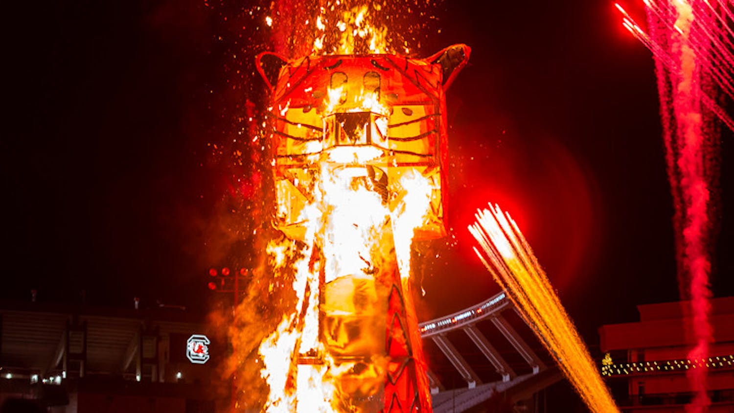 The blaze begins as the flames quickly catch and spread throughout the 32.5-foot-tall Celmson Tiger Statue. Fireworks are set off in the background for added effect.