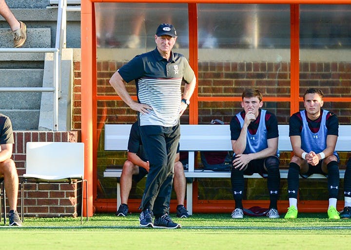 &nbsp;Mark Berson, head coach of South Carolina men’s soccer, stands in front of his player sitting on the bench.&nbsp;