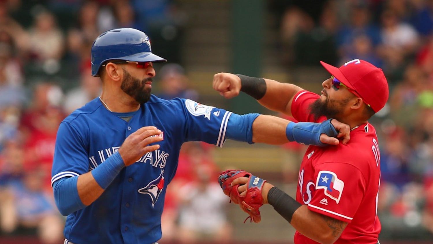 Toronto Blue Jays Jose Bautista (19) gets hit by Texas Rangers second baseman Rougned Odor (12) after Bautista slid into second in the 8th inning at Globe Life Park on May 15, 2016 in Arlington, Texas. The Rangers won 7-6. (Richard W. Rodriguez/Fort Worth Star-Telegram/TNS)  