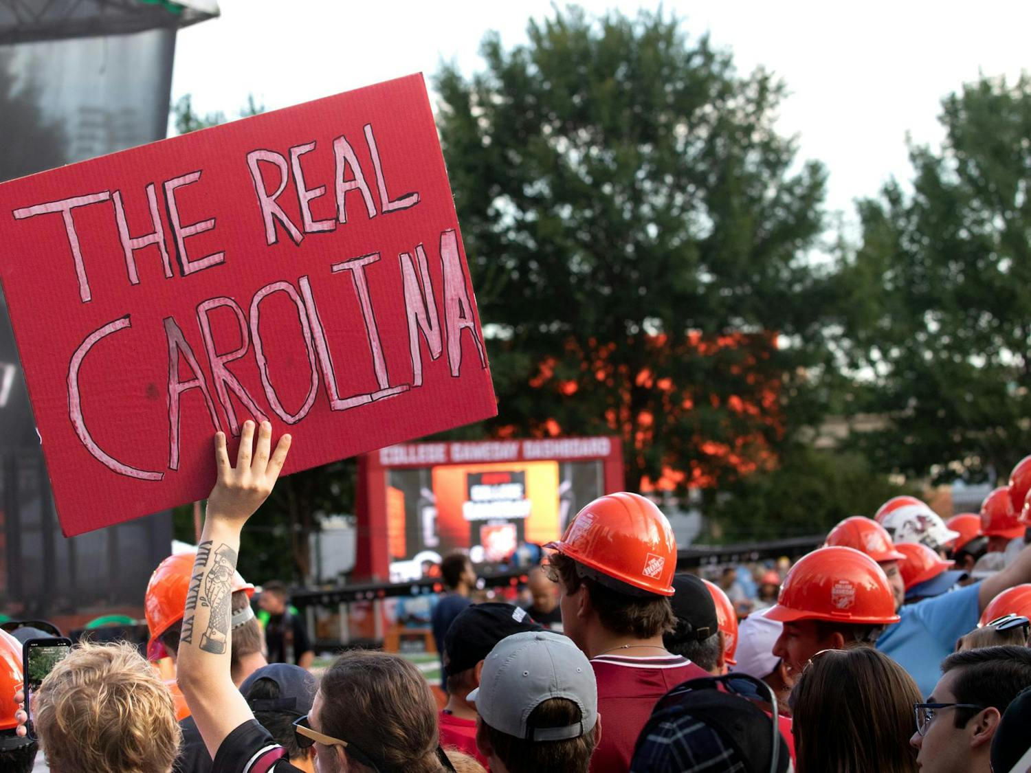 A Gamecocks fan holds up a sign claiming South Carolina is “The real Carolina” during College GameDay. The broadcast in Charlotte leads up to the "Battle of the Carolinas" on Sept. 2, 2023.
