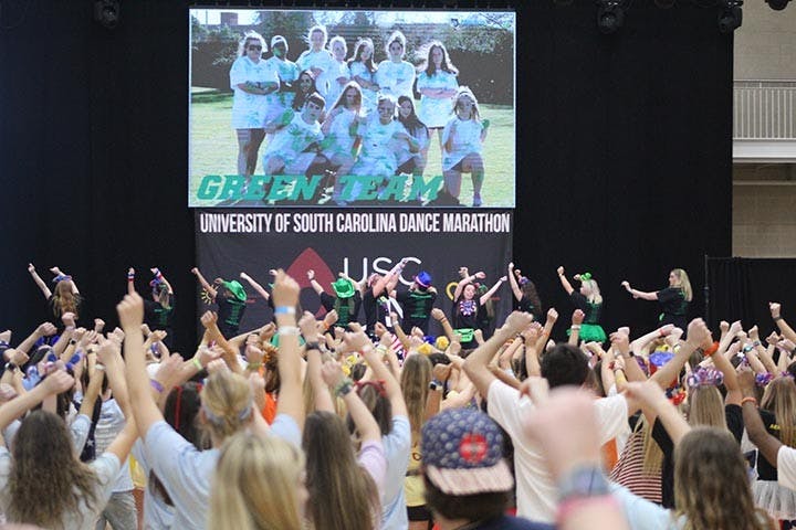 Volunteers and attendees spin around as the Green Team leads them in a line dance at Dance Marathon's Main Event Feb. 29, 2020.