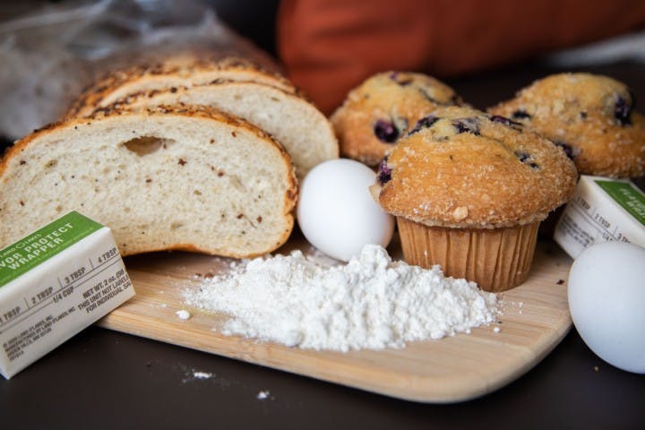 Baking ingredients are laid out across a table.