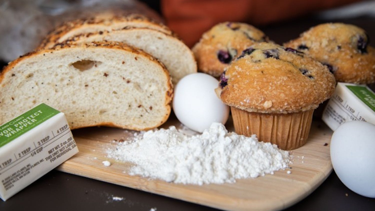 Baking ingredients are laid out across a table.