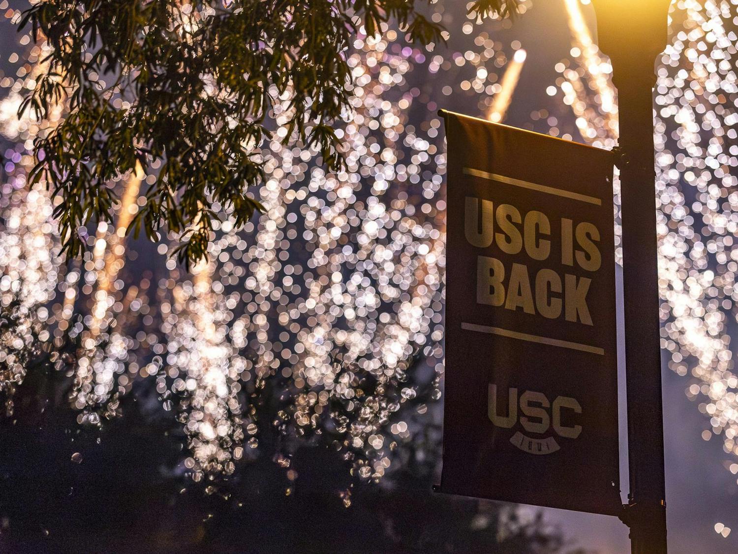 A banner with the slogan "USC IS BACK" sits in front of the First Night Carolina firework finale on Aug. 23, 2023. The event celebrates the start of the new school year.