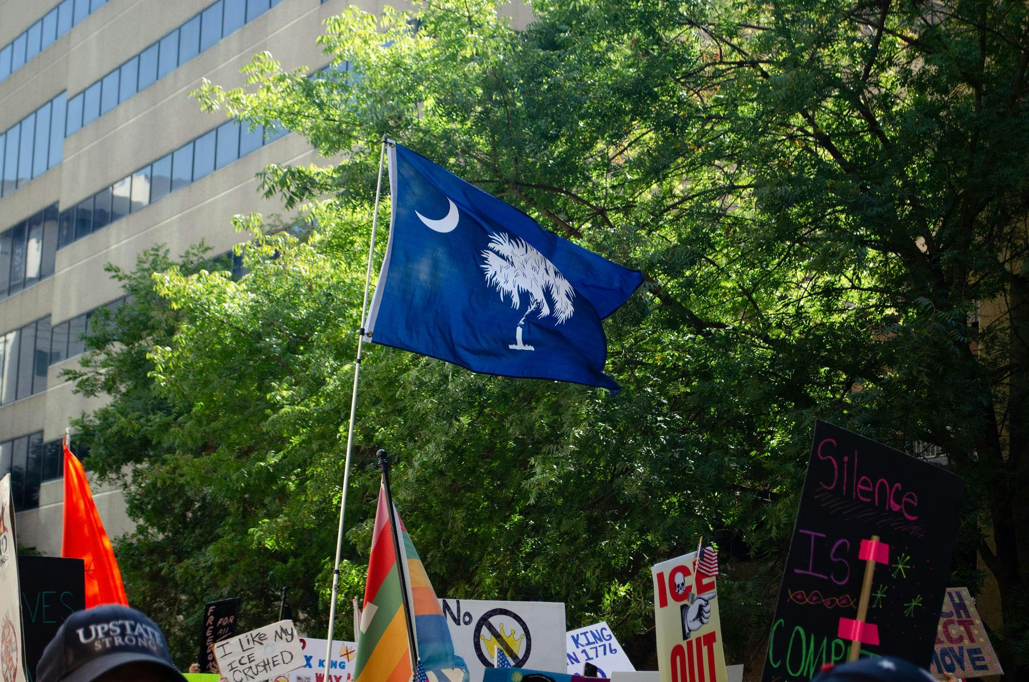 A protester waves the flag of South Carolina at a "No Kings" protest in Columbia, South Carolina on Oct. 18, 2025. The "No Kings" protests are broadly opposed to President Donald Trump and his policies.