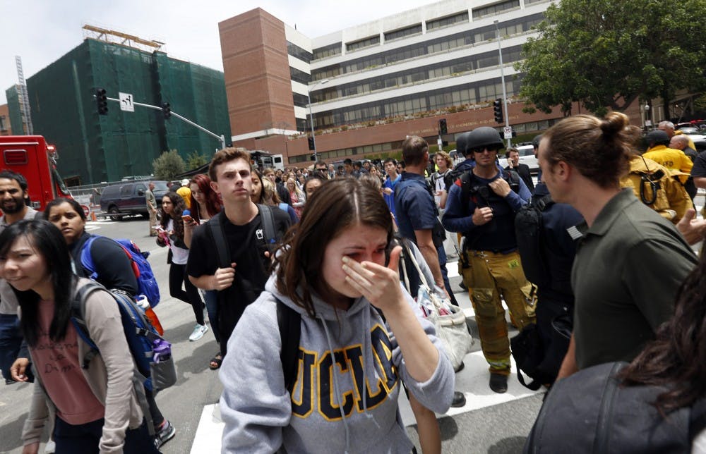 A tearful UCLA student joins hundreds of other students as they leave the UCLA campus after the lockdown was called off on Wednesday, June 1, 2016. (Genaro Molina/Los Angeles Times/TNS)