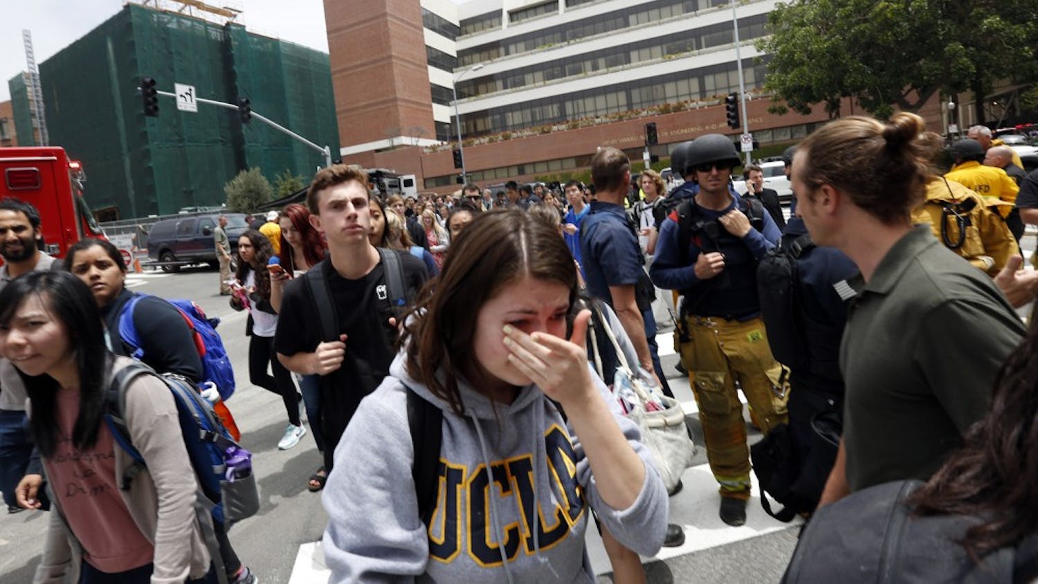 A tearful UCLA student joins hundreds of other students as they leave the UCLA campus after the lockdown was called off on Wednesday, June 1, 2016. (Genaro Molina/Los Angeles Times/TNS)