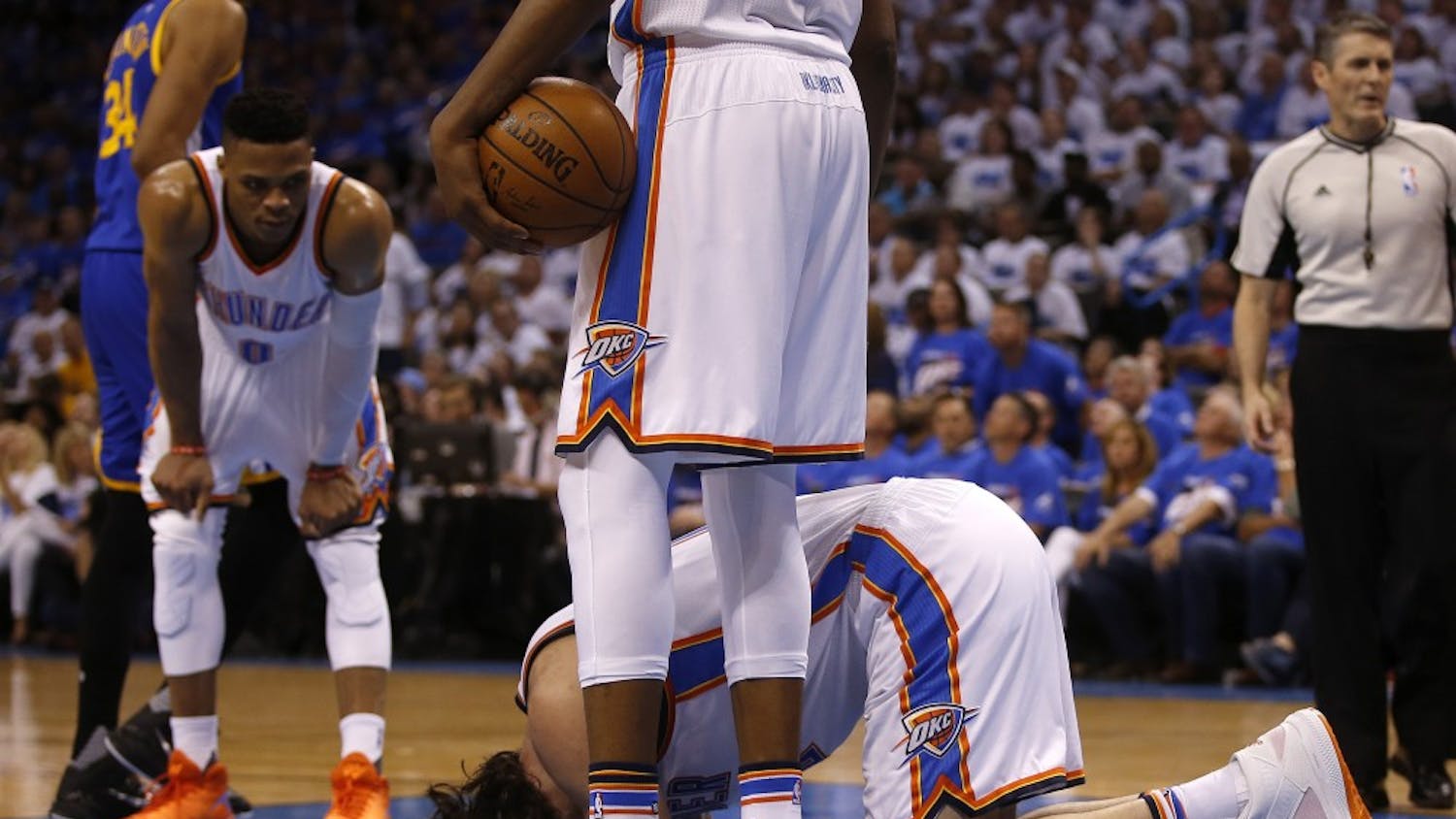 Oklahoma City Thunder's Steven Adams (12) kneels on the ground after being kicked by Golden State Warriors' Draymond Green (23) during the second quarteron Sunday, May 22, 2016, at Chesapeake Energy Arena in Oklahoma City. (Nhat V. Meyer/Bay Area News Group/TNS)