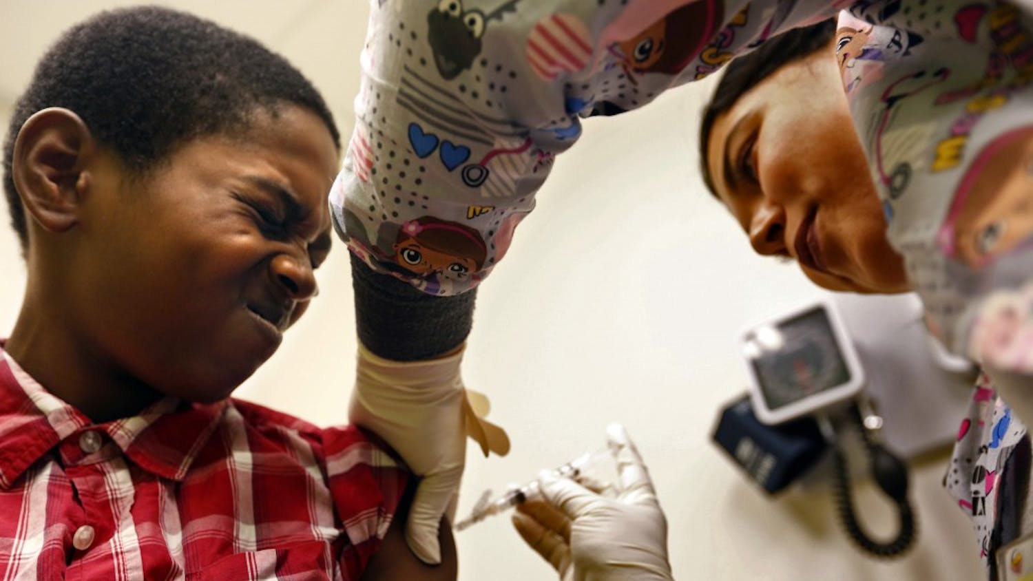 Desmond Sewell, 12, receives his vaccinations, including for TDAP against pertussis, or whooping cough, from Medical Assistant Jessica Reyes at the Lou Colen Children's Health and Wellness Center in Los Angeles on Aug. 4, 2017. (Genaro Molina/Los Angeles Times/TNS)