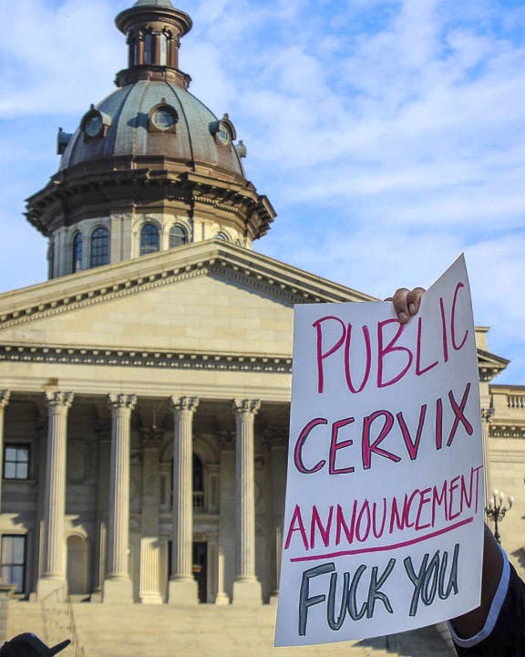 A protester covered in blood-colored paint holds up a pro-abortion sign labeled “I’ll Just Do It Myself” during the Dobbs v. Jackson protest at the South Carolina state capitol on June 25, 2022. The protest came as a response to the overturning of the landmark Roe v. Wade case earlier that June.