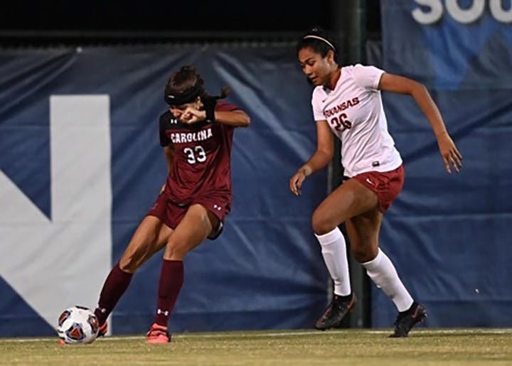 Junior midfielder Jyllissa Harris dribbles the ball around an Arkansas defender in the SEC Tournament semifinals. The Gamecocks fell to the Razorbacks 2-1.