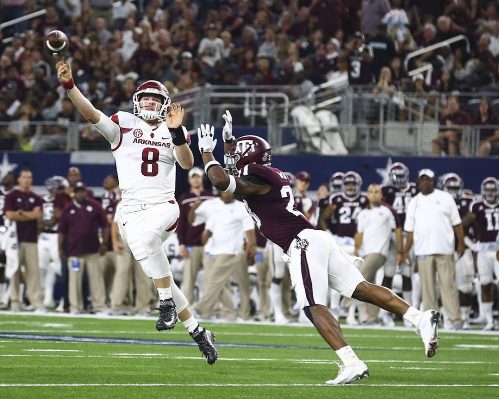 Arkansas quarterback Austin Allen (8) passes under pressure from Texas A&amp;M defensive back Armani Watts (23) in the second quarter at AT&amp;T Stadium in Arlington, Texas, on Saturday, Sept. 24, 2016. (Richard W. Rodriguez/Fort Worth Star-Telegram/TNS)