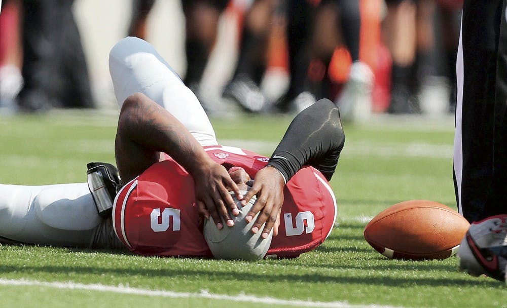 Ohio State Buckeyes quarterback Braxton Miller (5) lies injured in the first quarter against the San Diego State Aztecs at Ohio Stadium in Columbus, Ohio, Saturday, September 7, 2013. Ohio State beat San Diego State, 42-7. (Fred Squillante/Columbus Dispatch/MCT)
