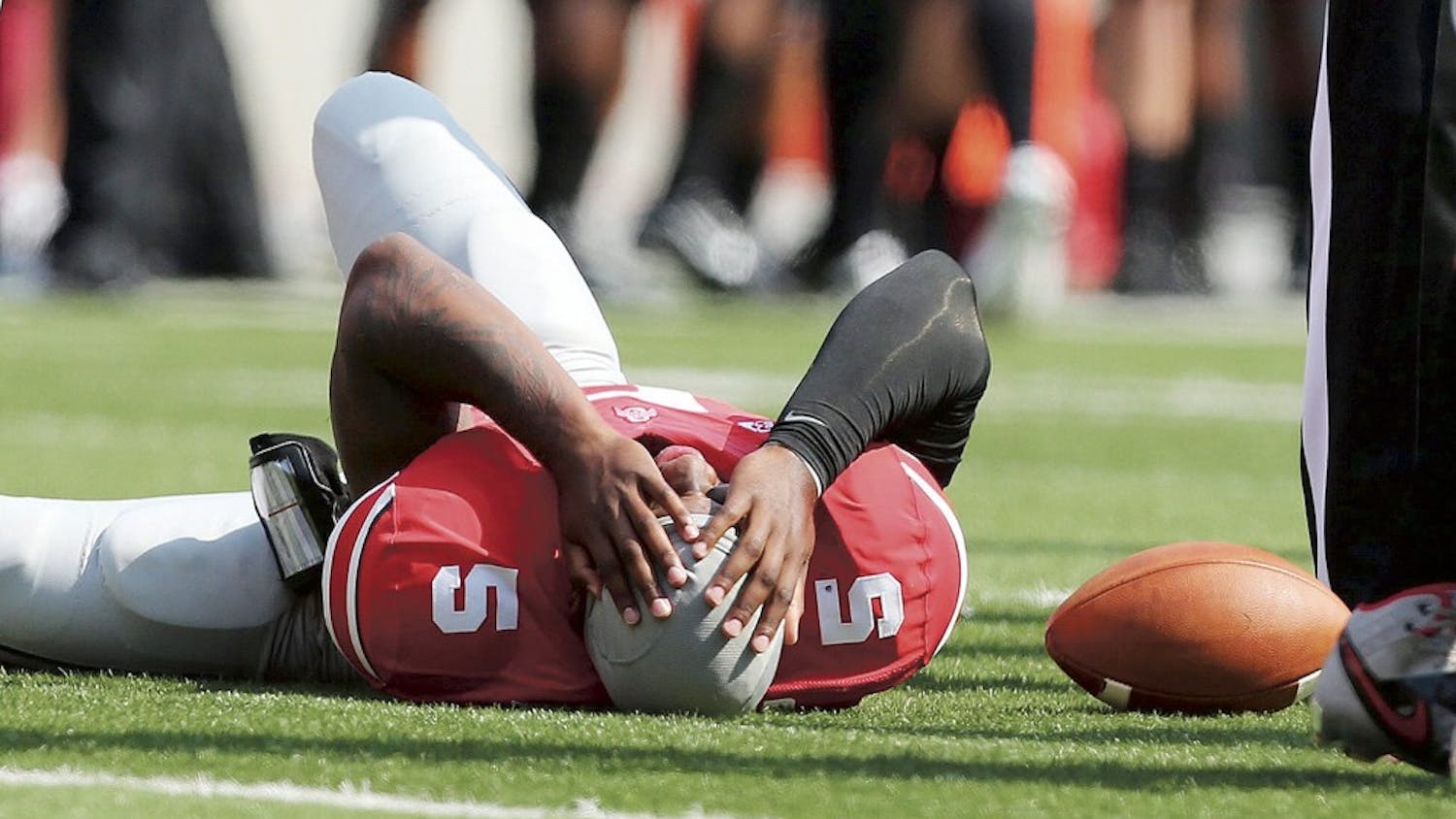 Ohio State Buckeyes quarterback Braxton Miller (5) lies injured in the first quarter against the San Diego State Aztecs at Ohio Stadium in Columbus, Ohio, Saturday, September 7, 2013. Ohio State beat San Diego State, 42-7. (Fred Squillante/Columbus Dispatch/MCT)