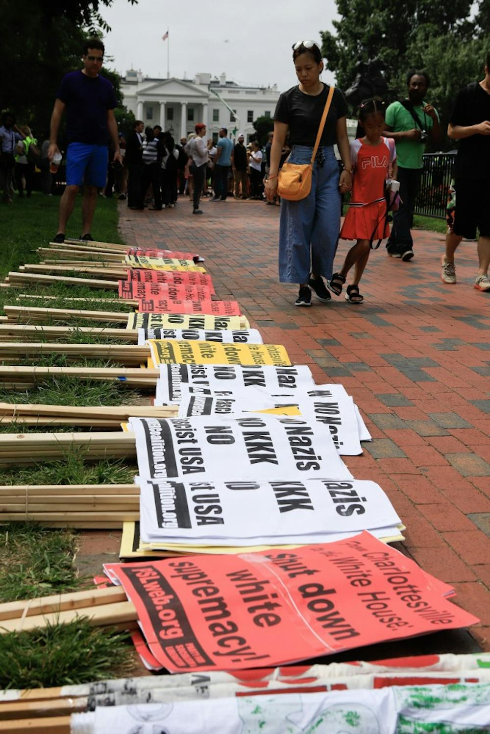 Stacked signs line the sidewalk in Lafayette Square Park on Sunday, Aug. 12, 2018 in Washington, D.C. ahead of planned protests on the anniversary of the Unite the Right rally in Charlottesville, Va. (Darryl Smith/TNS)