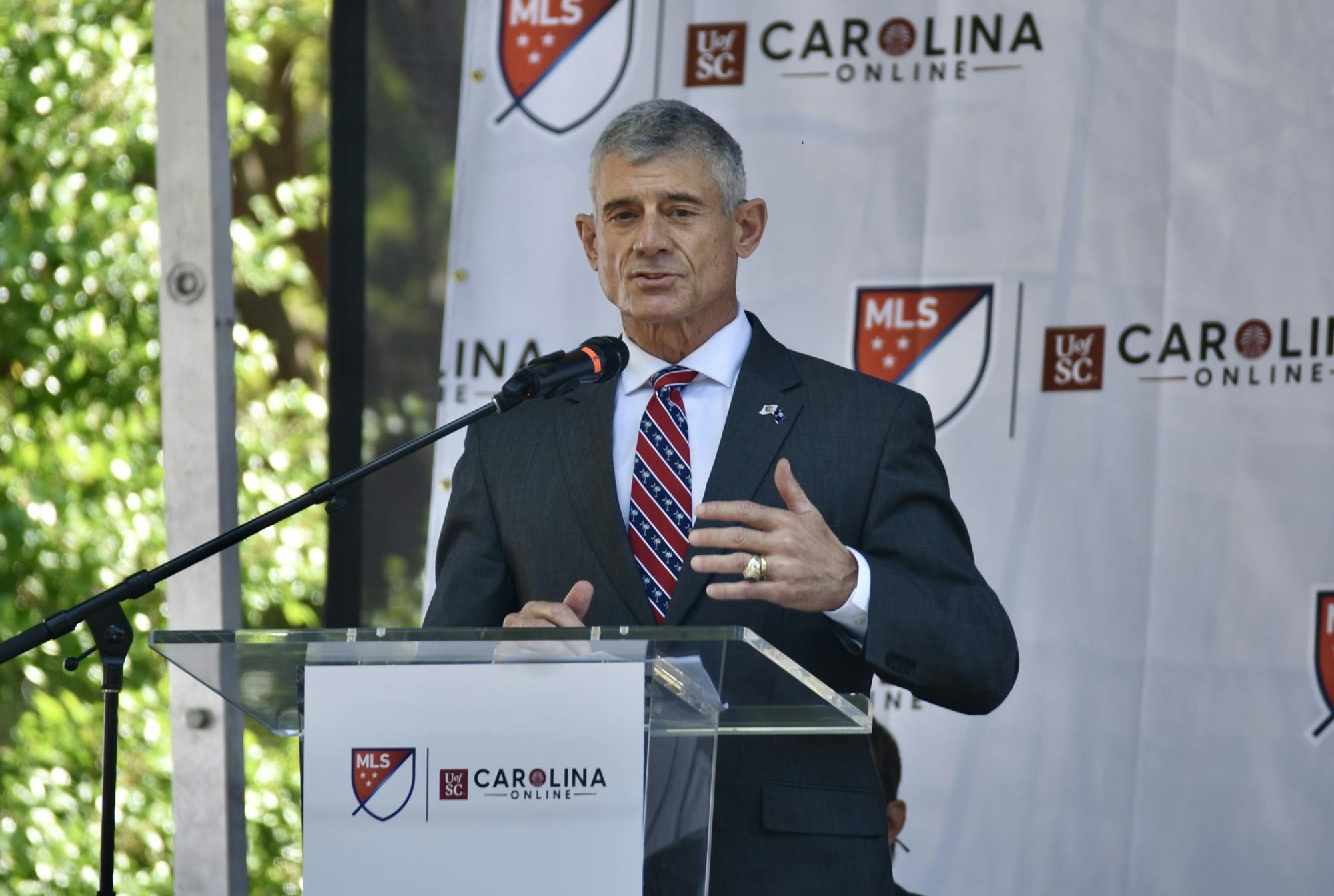  University President Bob Caslen stands at a podium and gives a speech to the crowd.