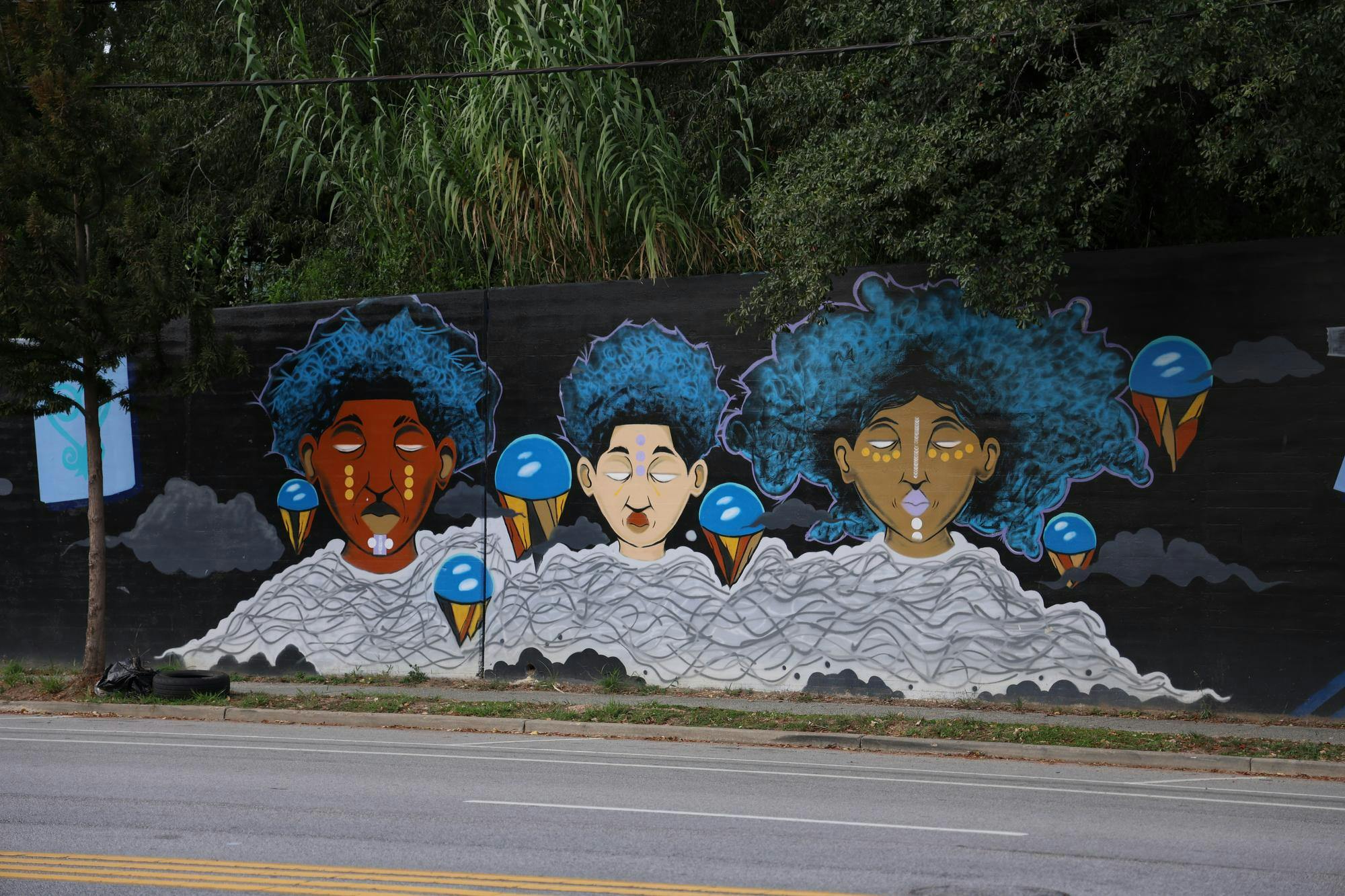 A triptych mural sits on Millwood Avenue on Sept. 16, 2025. The mural was created by Karl Zurfluh, Brandon Donahue and Cedric Umoja.