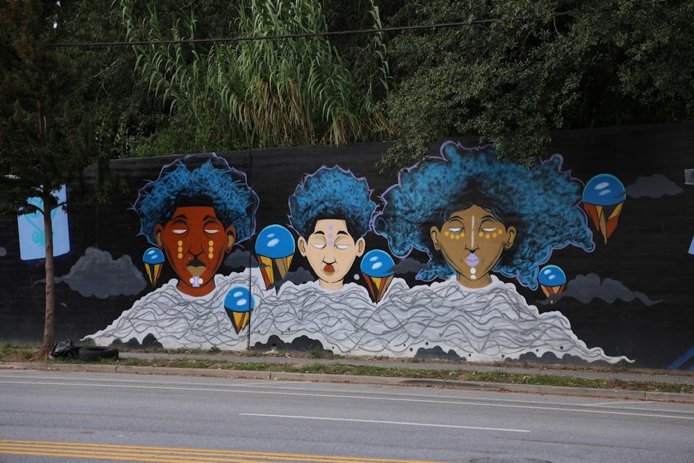 <p>A triptych mural sits on Millwood Avenue on Sept. 16, 2025. The mural was created by Karl Zurfluh, Brandon Donahue and Cedric Umoja.</p>