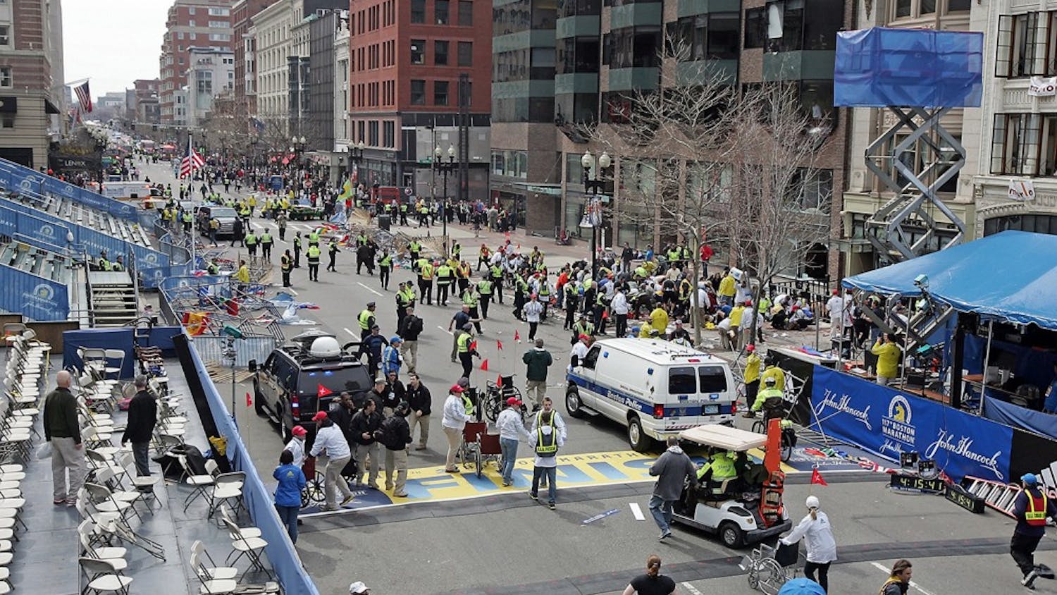Emergency personnel assist the victims at the scene of a bomb blast during the Boston Marathon in Boston, Massachusetts, Monday, April 15, 2013. (Stuart Cahill/Boston Herald/MCT)