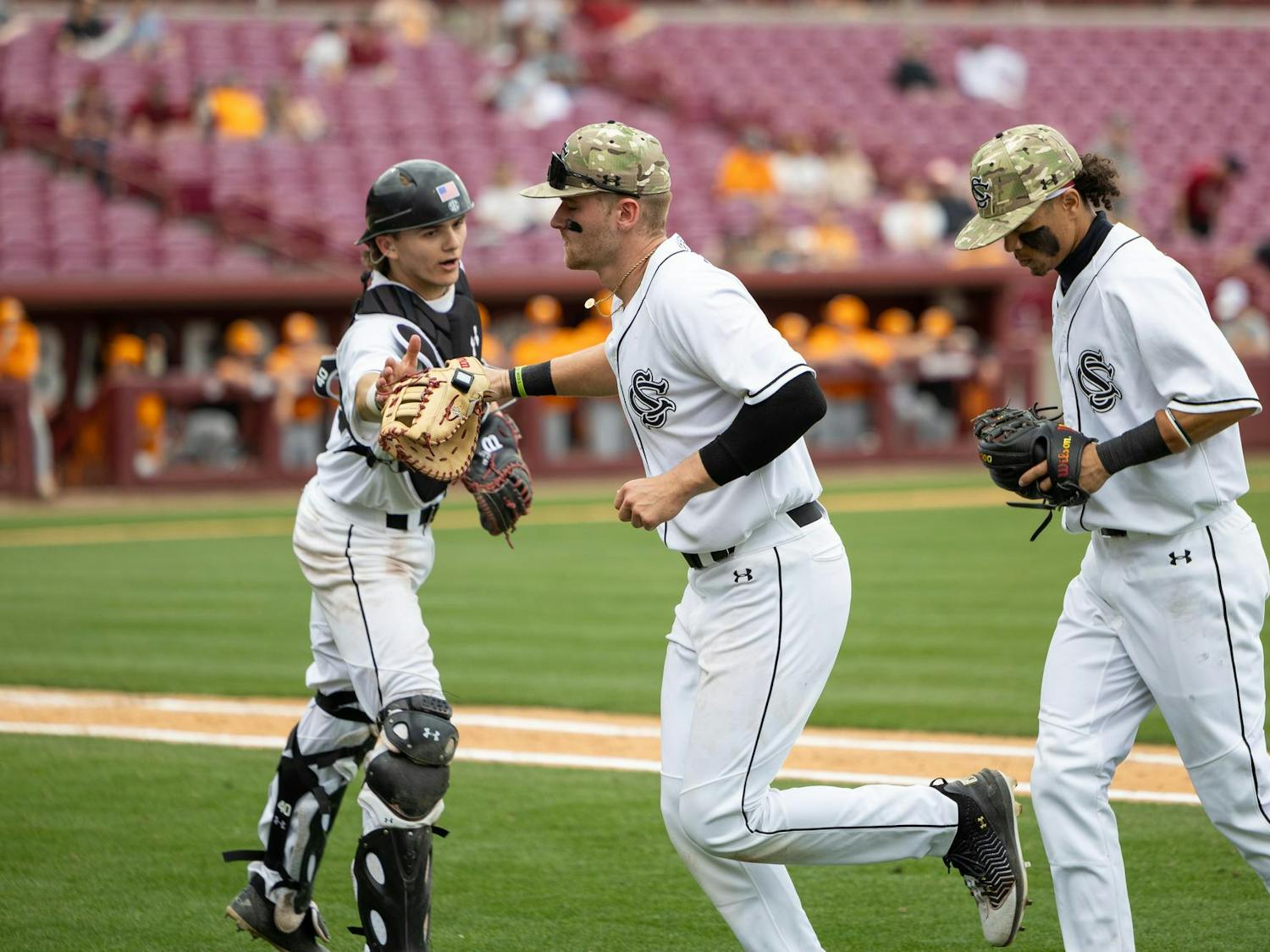 Freshman catcher Gavin Braland (left) high-fives freshman infielder Beau Hollins after the top of the ninth inning against No. 1 Tennessee on March 30, 2025, at Founders Park. The Gamecocks lost their series against the Volunteers 3-0.
