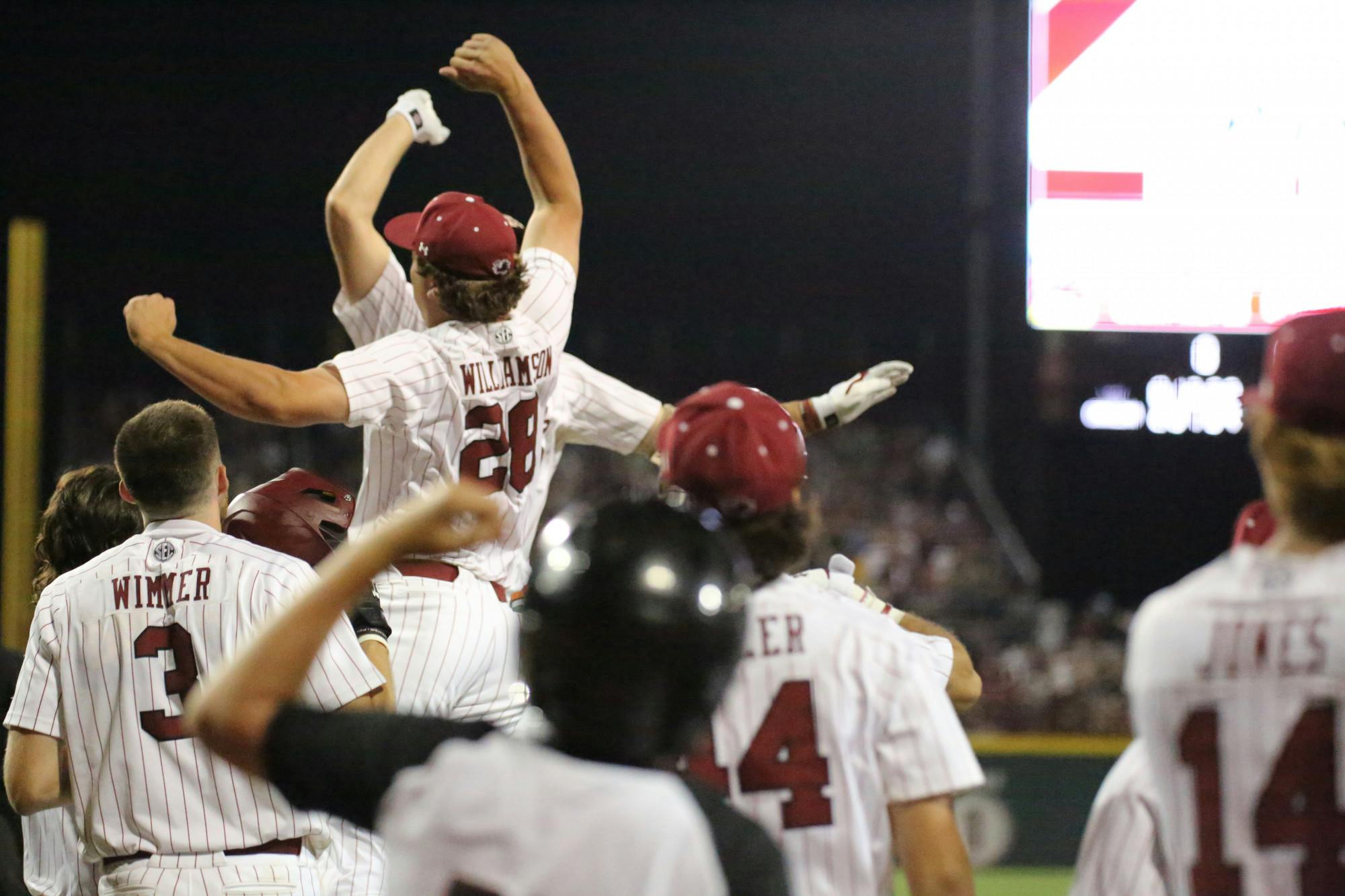 Freshman pitcher Austin Williamson congratulates freshman outfielder Ethan Petry on his 384-foot grand slam by jumping with excitement after he crosses home plate. Petry’s two home runs and eight RBI during the first game of the two-game series against LSU helped South Carolina win 13-5.