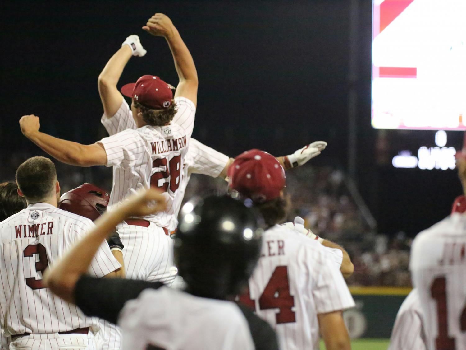 Freshman pitcher Austin Williamson congratulates freshman outfielder Ethan Petry on his 384-foot grand slam by jumping with excitement after he crosses home plate. Petry’s two home runs and eight RBI during the first game of the two-game series against LSU helped South Carolina win 13-5.