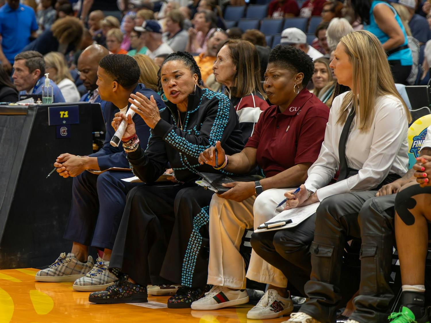 Women's basketball head coach Dawn Staley (left, paper in hand) talks to her players on the court during the National Championship game against UConn on April 6, 2025. Staley has led the Gamecocks to three National Championship titles in her time at South Carolina.