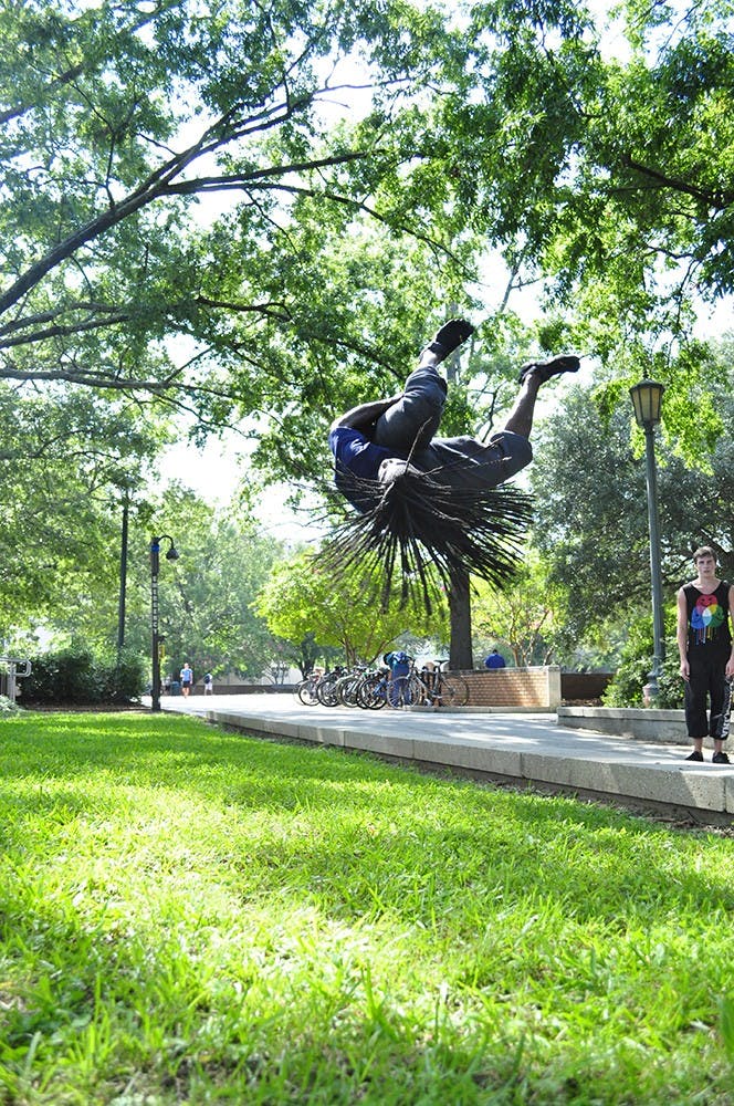 	Johnson demonstrating a step-up side flip near Thomas Cooper
