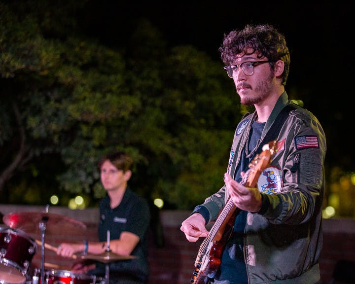 Fourth-year computer science student Sam Lowry (left) and fourth-year psychology and biology student Carson Dick (right), the drummer and bassist for Cockpit perform during the band's set at the Battle of the Bands on Oct. 5, 2022. &nbsp;The music competition brought a cappella, folk, rap and rock to the Russel House Patio in a variety of performances.&nbsp;