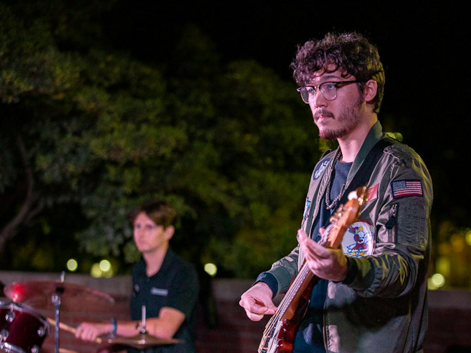 Fourth-year computer science student Sam Lowry (left) and fourth-year psychology and biology student Carson Dick (right), the drummer and bassist for Cockpit perform during the band's set at the Battle of the Bands on Oct. 5, 2022. &nbsp;The music competition brought a cappella, folk, rap and rock to the Russel House Patio in a variety of performances.&nbsp;