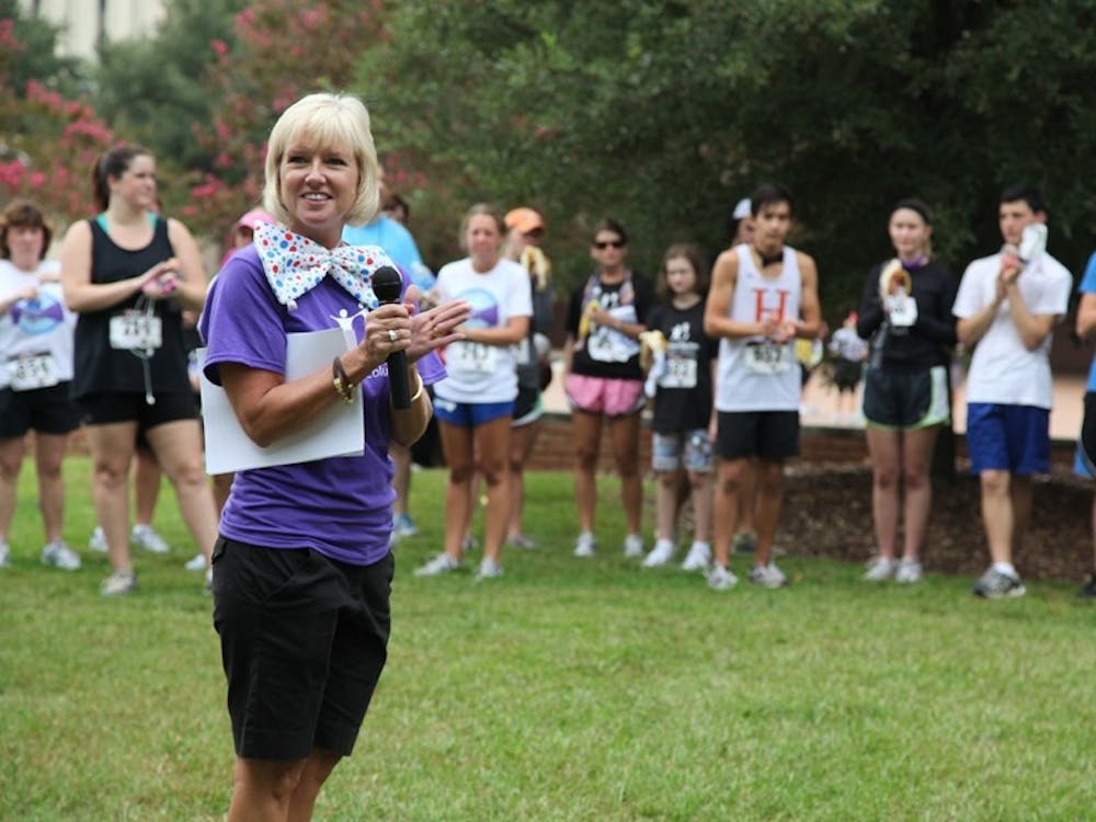 Jennifer Harding, a member of Big Brothers Big Sisters of Greater Columbia’s board of directors, speaks at the organization’s bow tie-heavy 5K run Saturday.