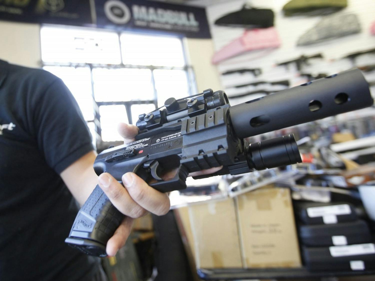 Jordan Baylon, 22, holds a realistic-looking air gun. For him and many others in the world of airsoft fighting, the appeal of the weapons lies in their realism. (Bob Chamberlin/Los Angeles Times/TNS)