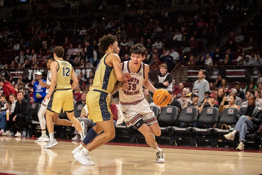 <p>FILE — Senior guard Mike Sharavjamts dribbles the ball around an opposing player during the game against Charleston Southern University on Nov. 28, 2025. Sharavjamts has averages a career high 53.6% field goal rate during his first season with the Gamecocks. </p>