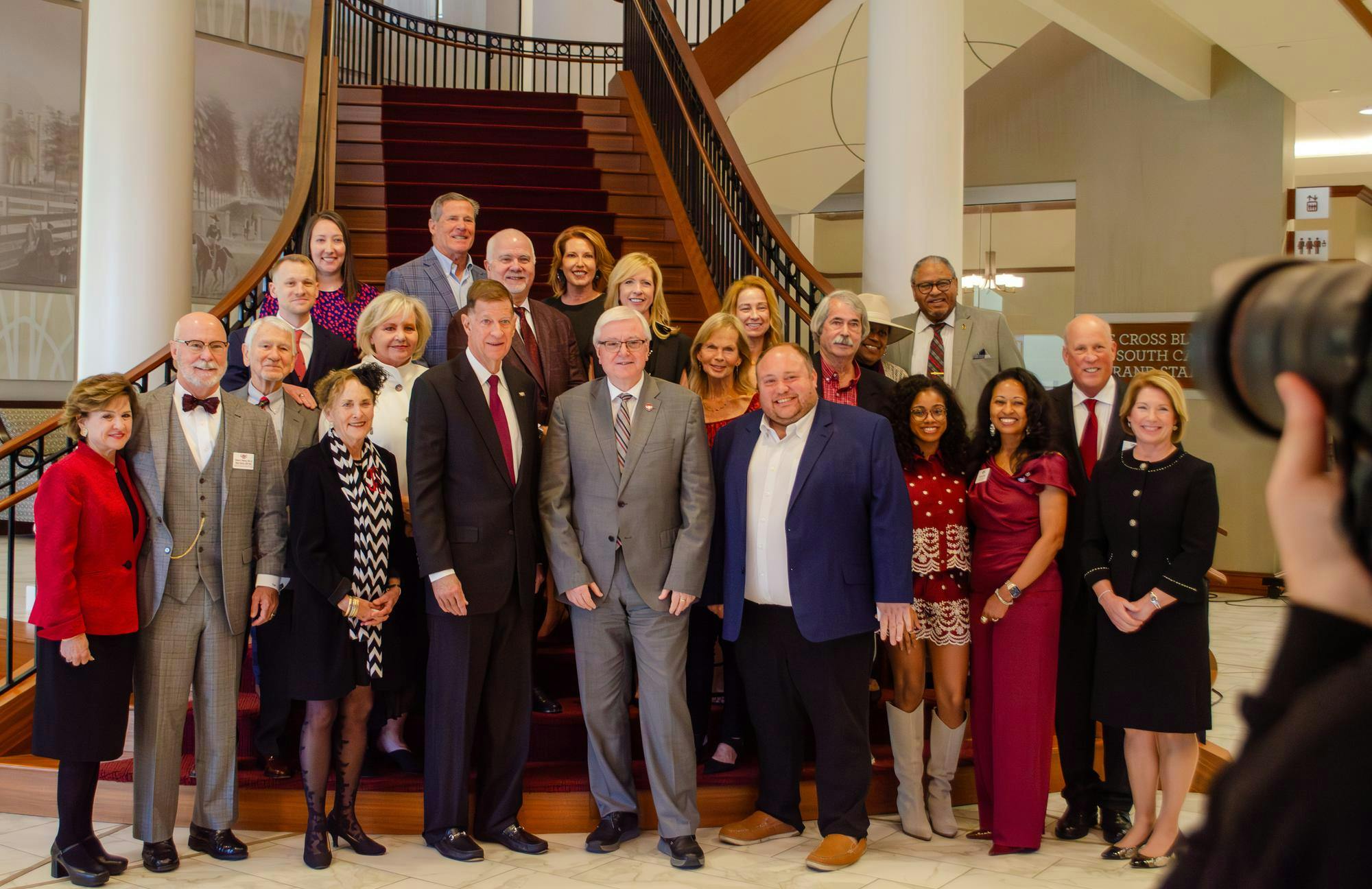 USC President Michael Amiridis poses for a picture with award winners and their families at an alumni awards ceremony at the Pastides Alumni Center in Columbia, South Carolina on Oct. 24, 2025. Six awards were presented by Tiffany Foxworth, CEO of the USC Alumni Association.