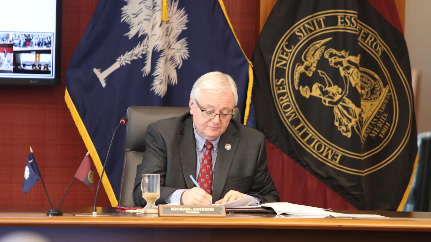 University of South Carolina President Michael Amiridis takes notes during a board of trustees meeting on March 18, 2024. Amiridis is serving as the university’s 30th president.