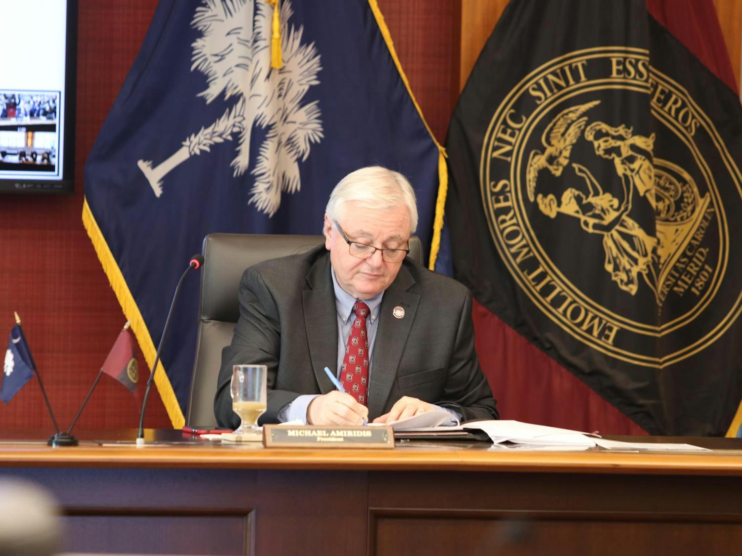 University of South Carolina President Michael Amiridis takes notes during a board of trustees meeting on March 18, 2024. Amiridis is serving as the university’s 30th president.