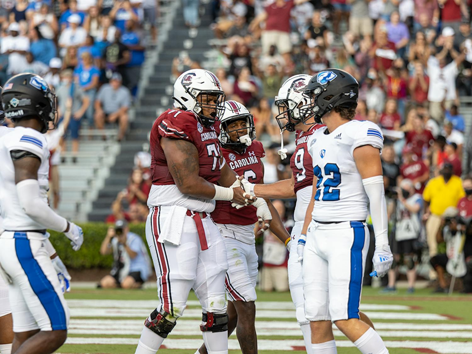 Fifth-year tight end Nick Muse and redshirt senior offensive lineman Eric Douglas celebrate a touchdown pass from graduate student quarterback Zeb Noland. Muse ran for a 2-point conversion, bringing the Gamecocks' score to 8 at the top of the first quarter.