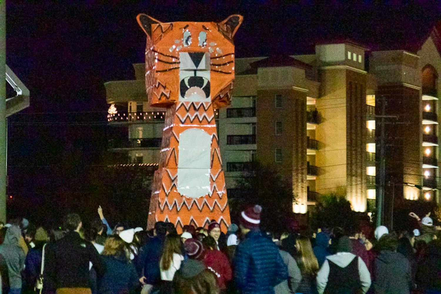 The 30-foot tall, orange and white, Clemson Tiger statue towers over a large crowd of 鶹С򽴫ý students on Nov. 21, 2022. The tiger was constructed in the middle of the Bluff Road Intermural field by the 鶹С򽴫ý American Society of Mechanical Engineers and Society of Hispanic Professional Engineers constructed the effigy for this year's event.